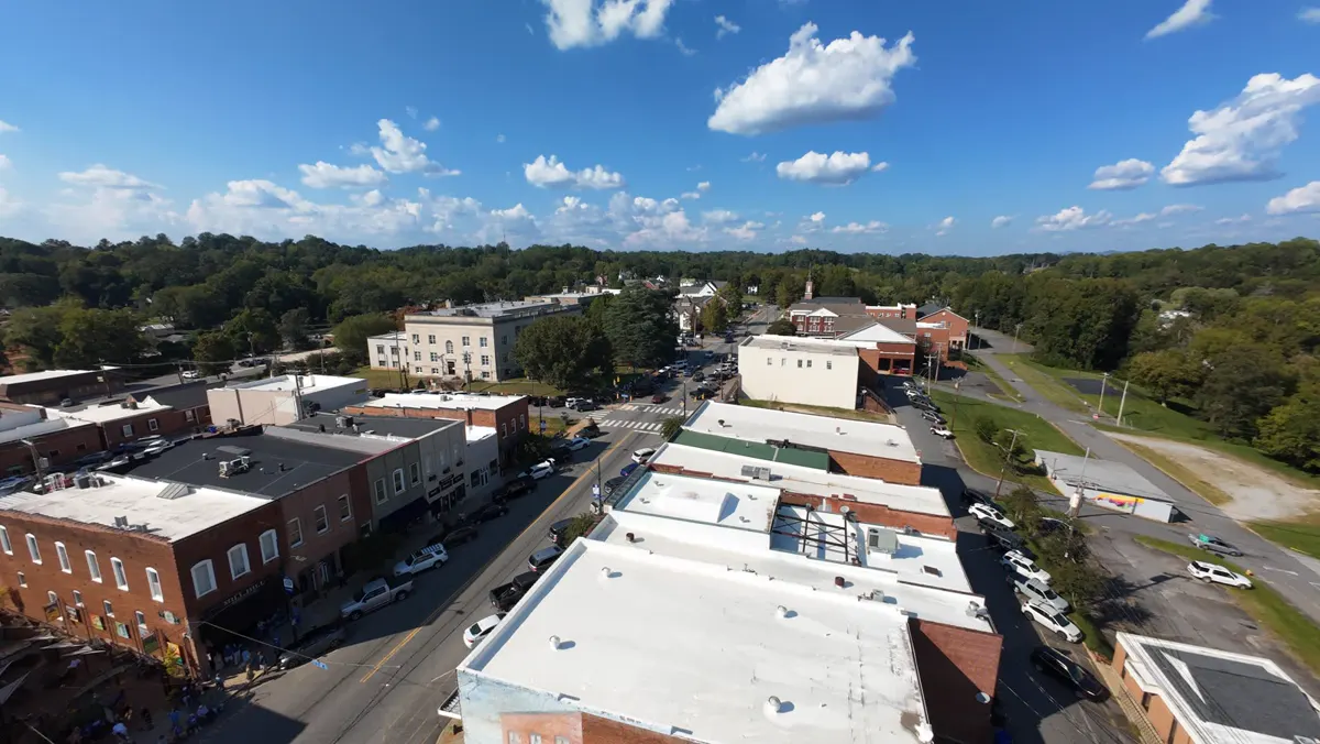 Aerial drone photograph of a property and surrounding neighborhood